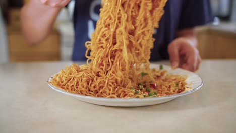 mixing a plate of dry instant noodles