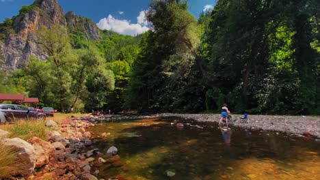 river and cave in mountain with people