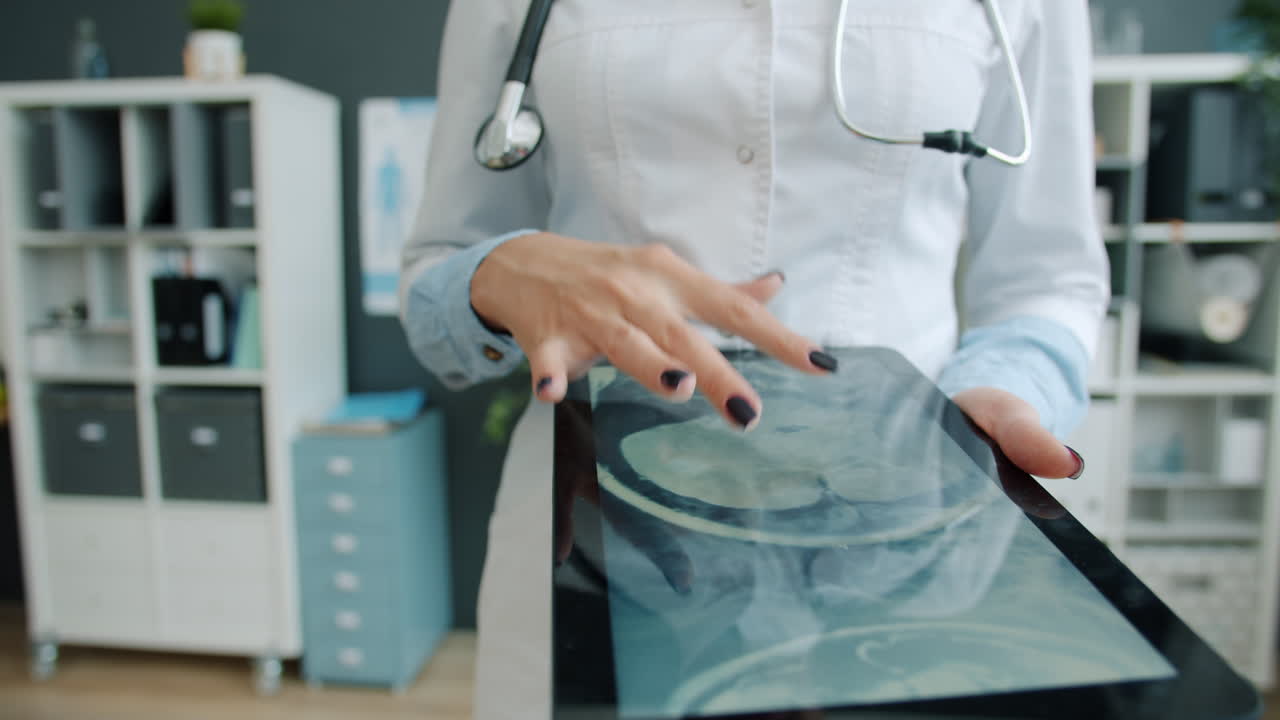 Doctor reviewing medical images on tablet