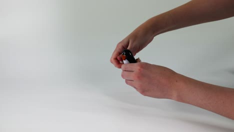 hands manipulating a small black object