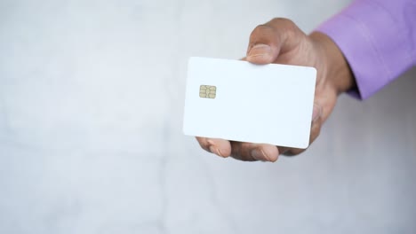 hand holding a blank white card