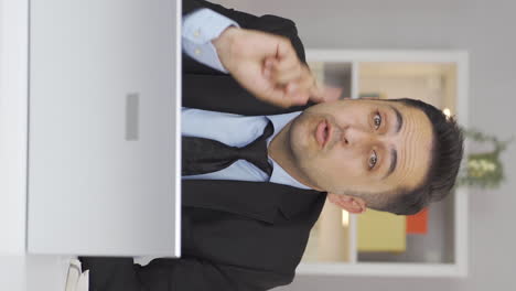 vertical video of home office worker man nods to the camera, says no, no.