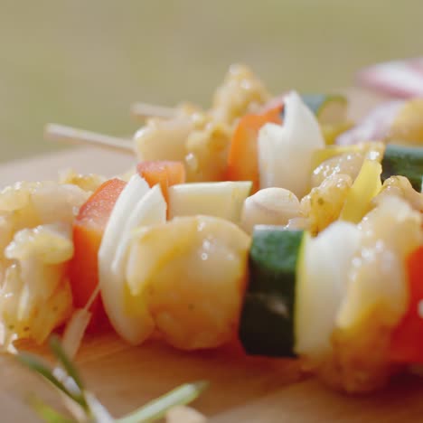 four vegetable kabobs on cutting board