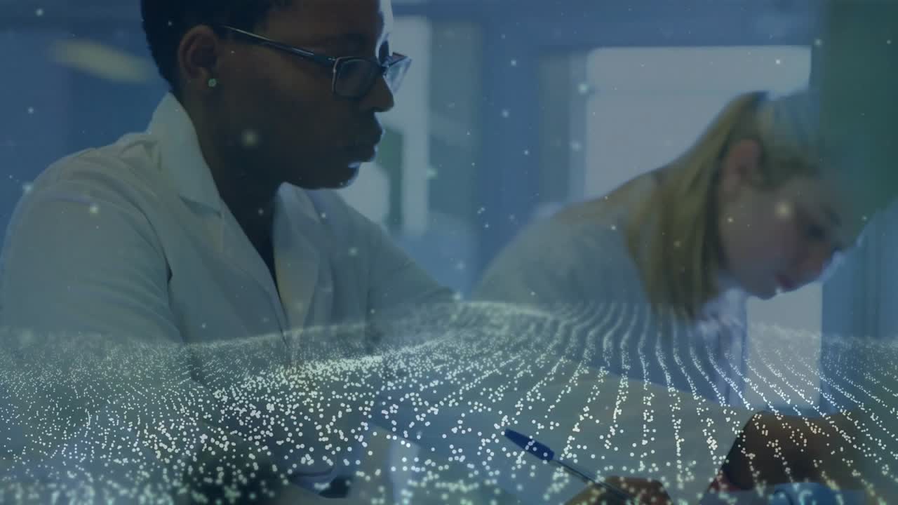 Lab scientists jotting notes and activating glowing grid while inspecting green solution clarity