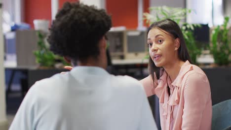 Video-of-focused-diverse-businesswoman-and-businessman-using-tablet-and-talking