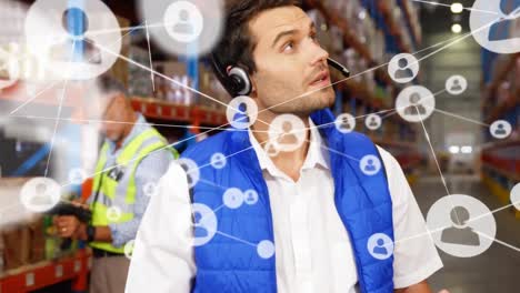 Animation-of-network-of-profile-icons-over-caucasian-male-supervisor-using-tablet-at-warehouse