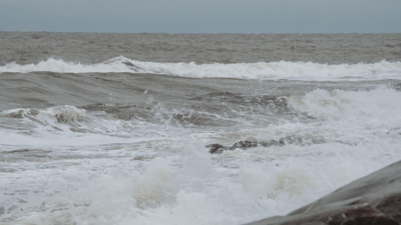 Slow motion waves spray in off the unfriendly seas of Canada's Hudson Bay and crash against the rocky shore