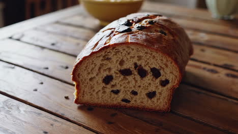 spreading butter on homemade raisin bread