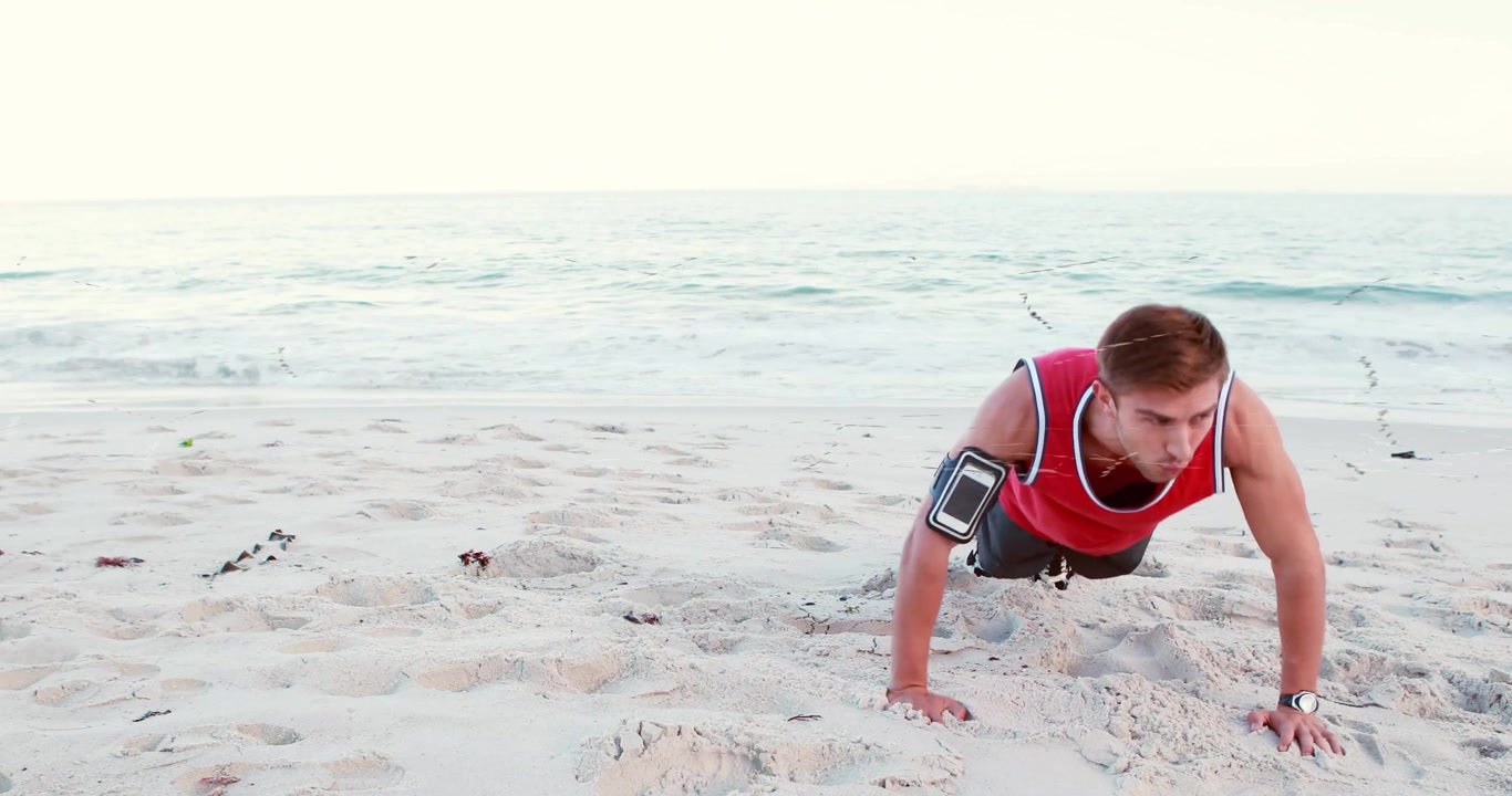 Exercising on beach, person doing push-ups with fitness tracker animation over ocean