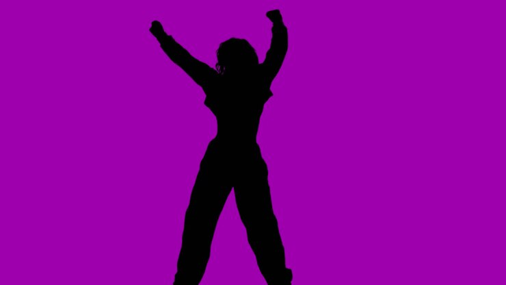 Studio Silhouette Of Woman Dancing Against Purple Background