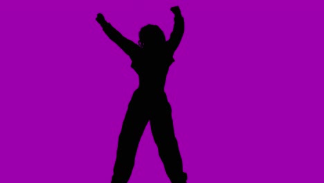 studio silhouette of woman dancing against purple background