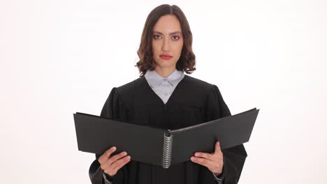female judge in black robe holding a book