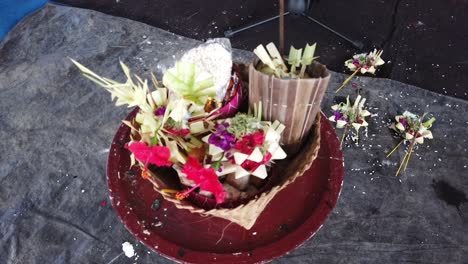 Closeup-of-Balinese-Flower-Offerings-Canang-Sari-Closeup-Religious-Hindu-Ceremony-Sage-and-Coconut-Leaves-Ornaments-for-Praying,-Bali-Hinduism