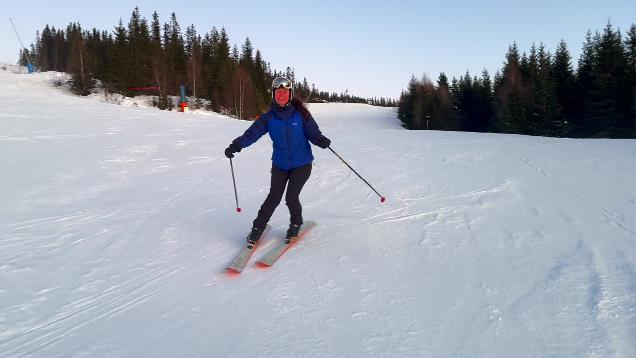 Telemark downhill skier skiing Hafjell Alpine ski resort Øyer mountain Norway Norge arctic sunset golden hour last run Olympic torch man Lillehammer clear skies groomed trail runs icy packed follow