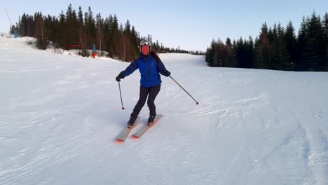 telemark downhill skier skiing hafjell alpine ski resort øyer mountain norway norge arctic sunset golden hour last run olympic torch man lillehammer clear skies groomed trail runs icy packed follow