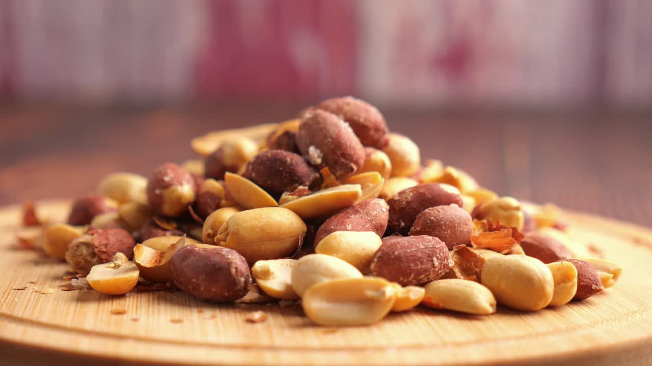 Pile of peanuts on a wooden board