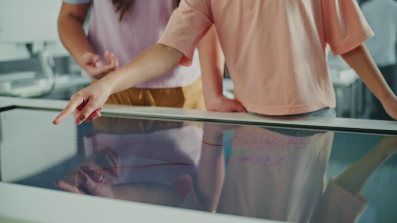 Children interacting with an interactive screen