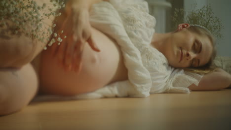 pregnant woman lying on floor portrait