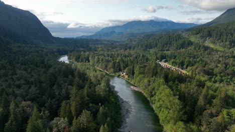 aerial view of a wide and mighty river flowing through the valley of the cascade mountains in washington