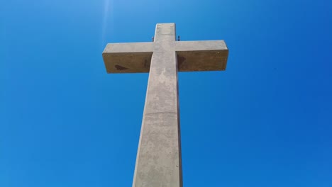 large concrete cross isolated against blue sky in mount filerimos, rhodes, greece