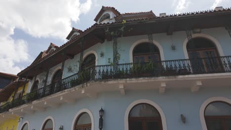 historic blue building with arched windows and balcony in casco viejo, panama city