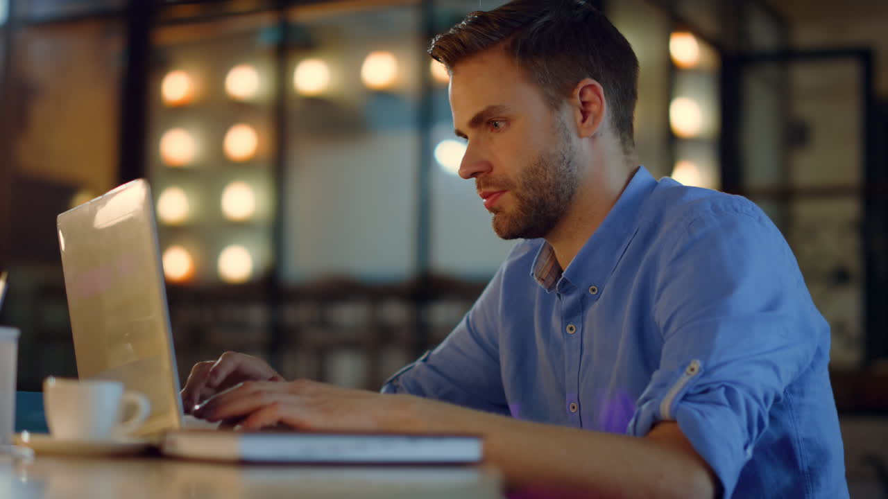 Business man typing on laptop in office. Tired entrepreneur working on computer.