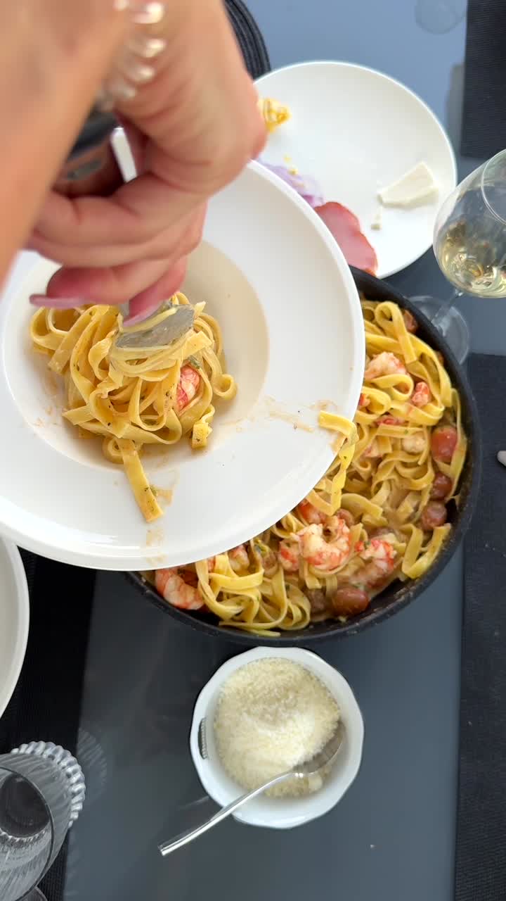 Woman serving pasta with shrimp