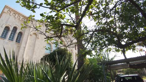 Holy-Trinity-Church-front-facade-main-gate-entrance-revealed-in-Limassol,-Cyprus---Wide-slow-push-in-Reveal-shot