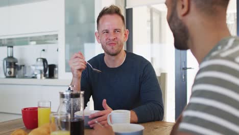 Multi-ethnic-gay-male-sitting-and-having-breakfast-talking