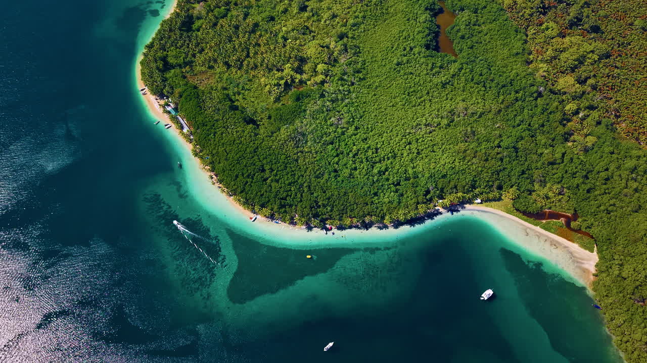 Boat Sailing Along The White Sand Beach In Colon Island In Bocas del Toro, Panama. - aerial shot