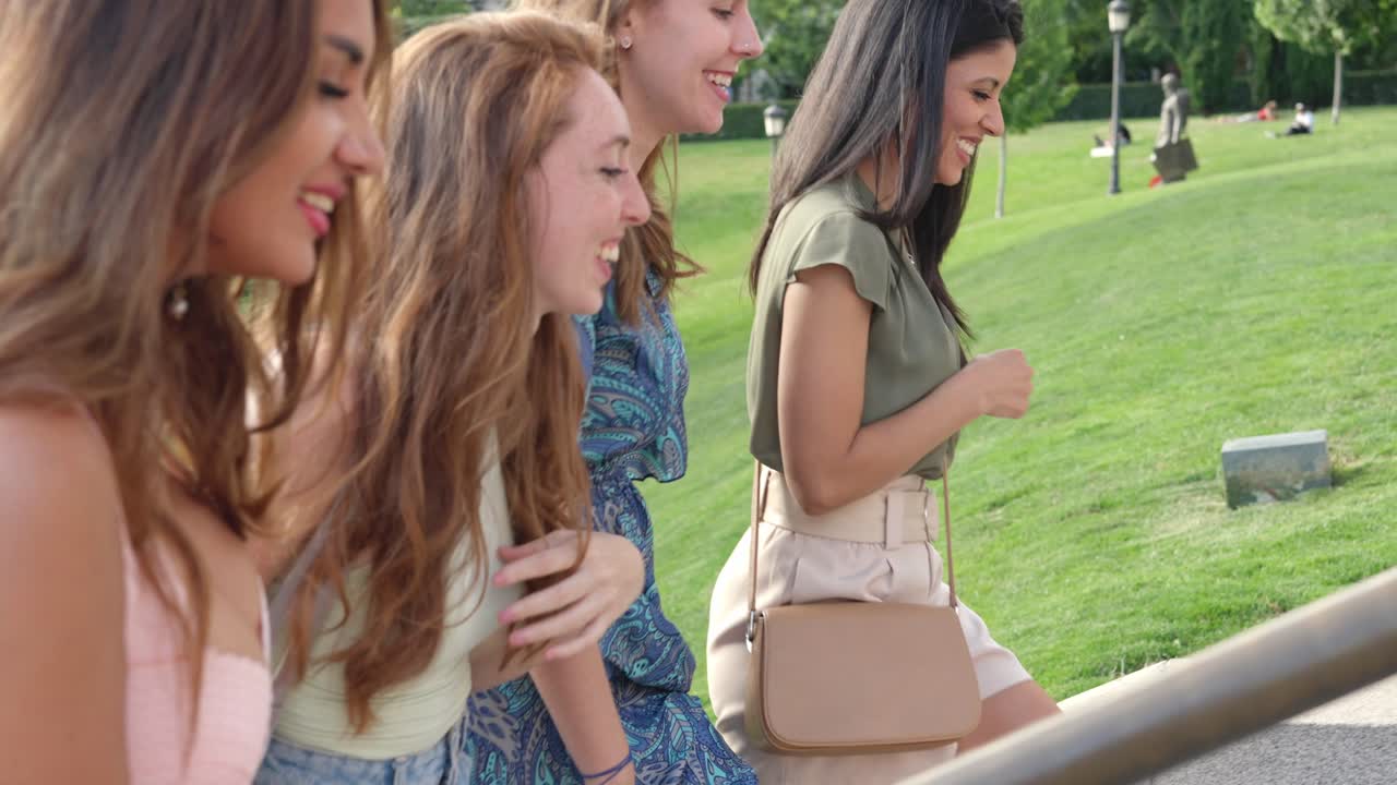 Happy Group of Friends Walking and Smiling in a Park