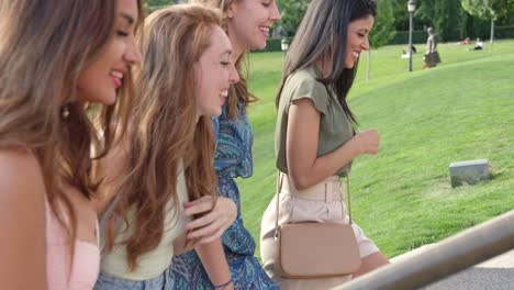 happy group of friends walking and smiling in a park