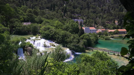 forest, waterfalls and houses in krka national park, croatia, wide pan