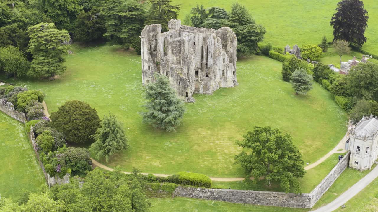 Aerial view of old Wardour Castle, surrounded by gardens and woods, heritage tourism