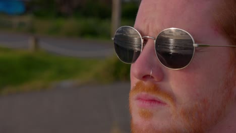 a close up shot of a man wearing sunglasses