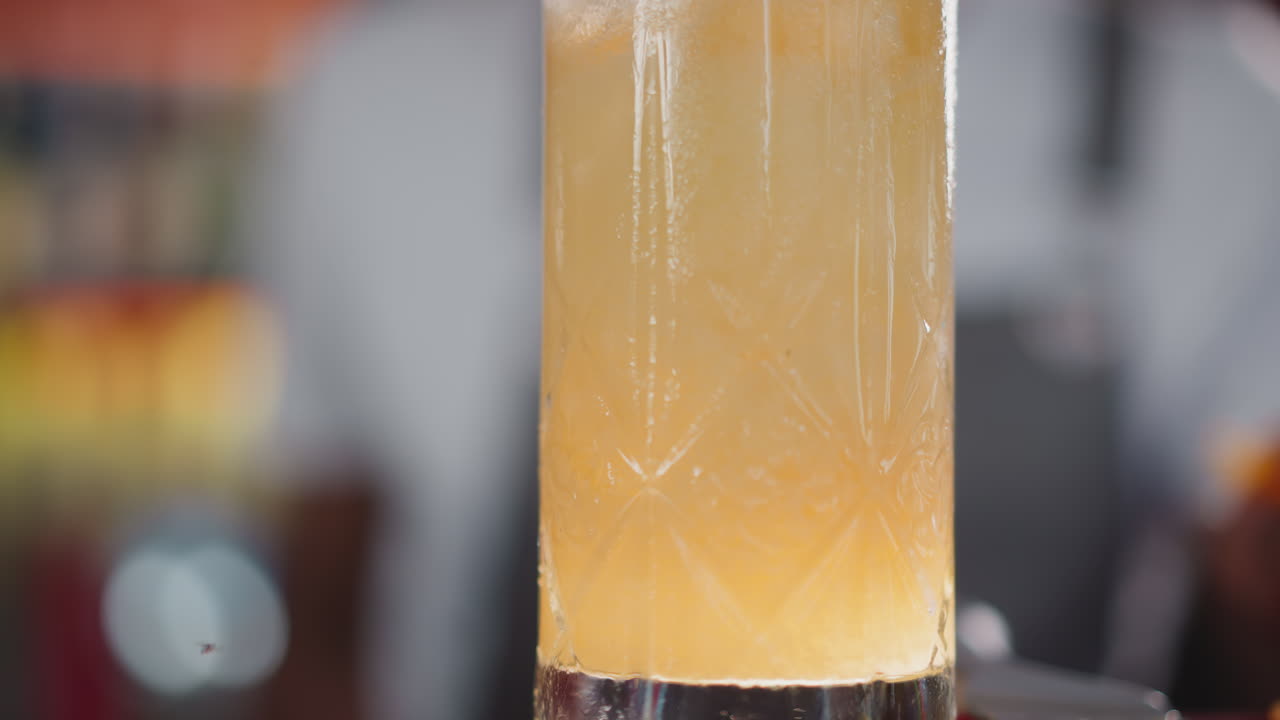 Glass of fresh cocktail with fruit juice closeup. Refreshing beverage to satisfy taste buds in bar. Exotic long drink cocktail for celebrations