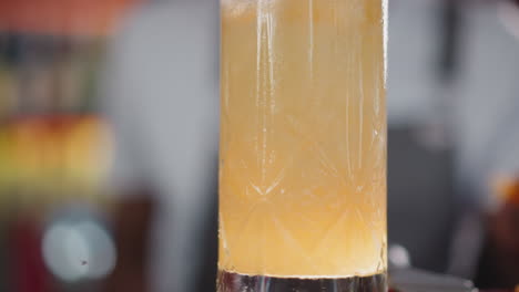 glass of fresh cocktail with fruit juice closeup. refreshing beverage to satisfy taste buds in bar. exotic long drink cocktail for celebrations