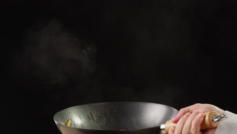 cooking colorful peppers in a wok