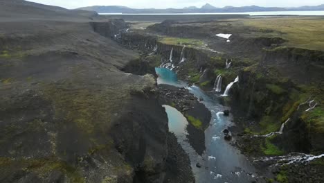 Aerial-view-of-Sigöldugljúfur-Canyon,-known-also-as-the-Valley-of-Tears,-with-fantastical-aqua-water-and-incredible-waterfalls-in-Iceland-in-the-summer-period