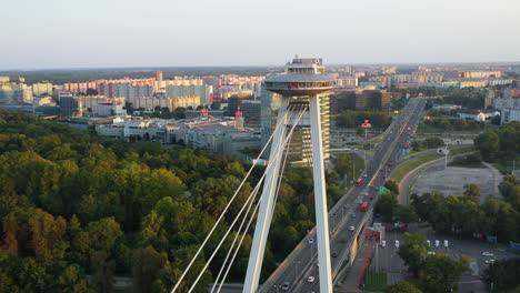 revealing drone shot of the bridge of the slovak national uprising starting near the observation deck in bratislava, slovakia