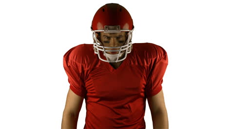 red serious american football player posing