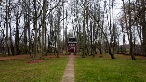 aerial drone view of a small chapel house in autumn