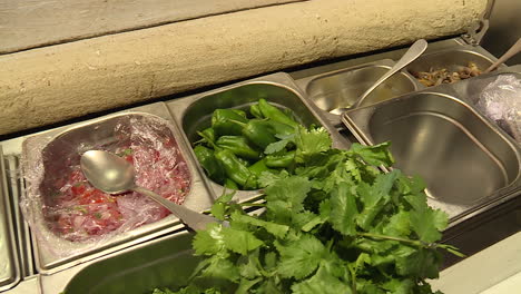 preparing fresh salsas and toppings at a restaurant