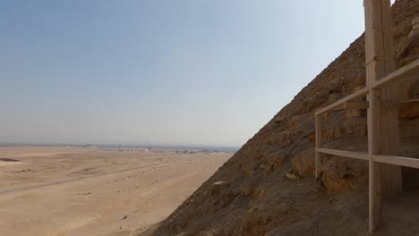 Looking-down-from-the-Dahshur-Red-Pyramid,-in-sunny-Cairo,-Egypt---Tilt-view