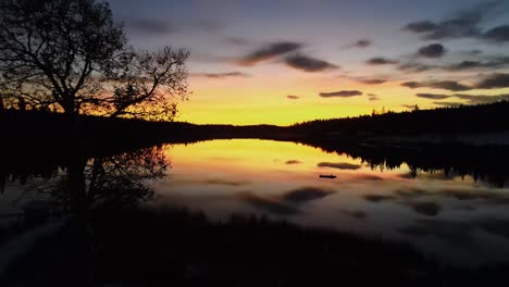 glimpse lake at colorful dramatic sunset from dock, aerial drone shot