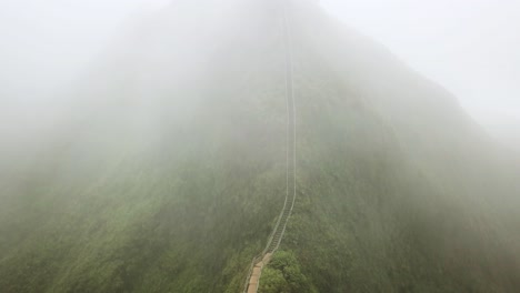 clouds moving over the haiku stairs trail, also known as stairway to heaven. aerial shot, oahu, hawaii.