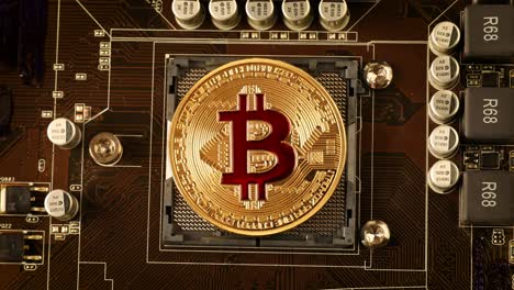 Gold Bit Coin BTC coins on the motherboard. Bitcoin is a worldwide cryptocurrency and digital payment system called the first decentralized digital currency.