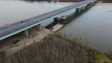 ascend backwards shot of traffic on polish bridge build to cross wisla vistula river