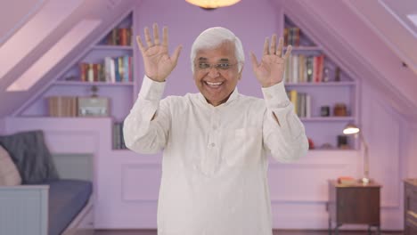 Happy-Indian-old-man-saying-hello-and-waving-hand