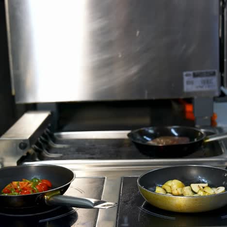 delicious fried mushrooms in a frying pan. unrecognizible chef turns mushrooms in frying pan. modern restaurant kitchen background